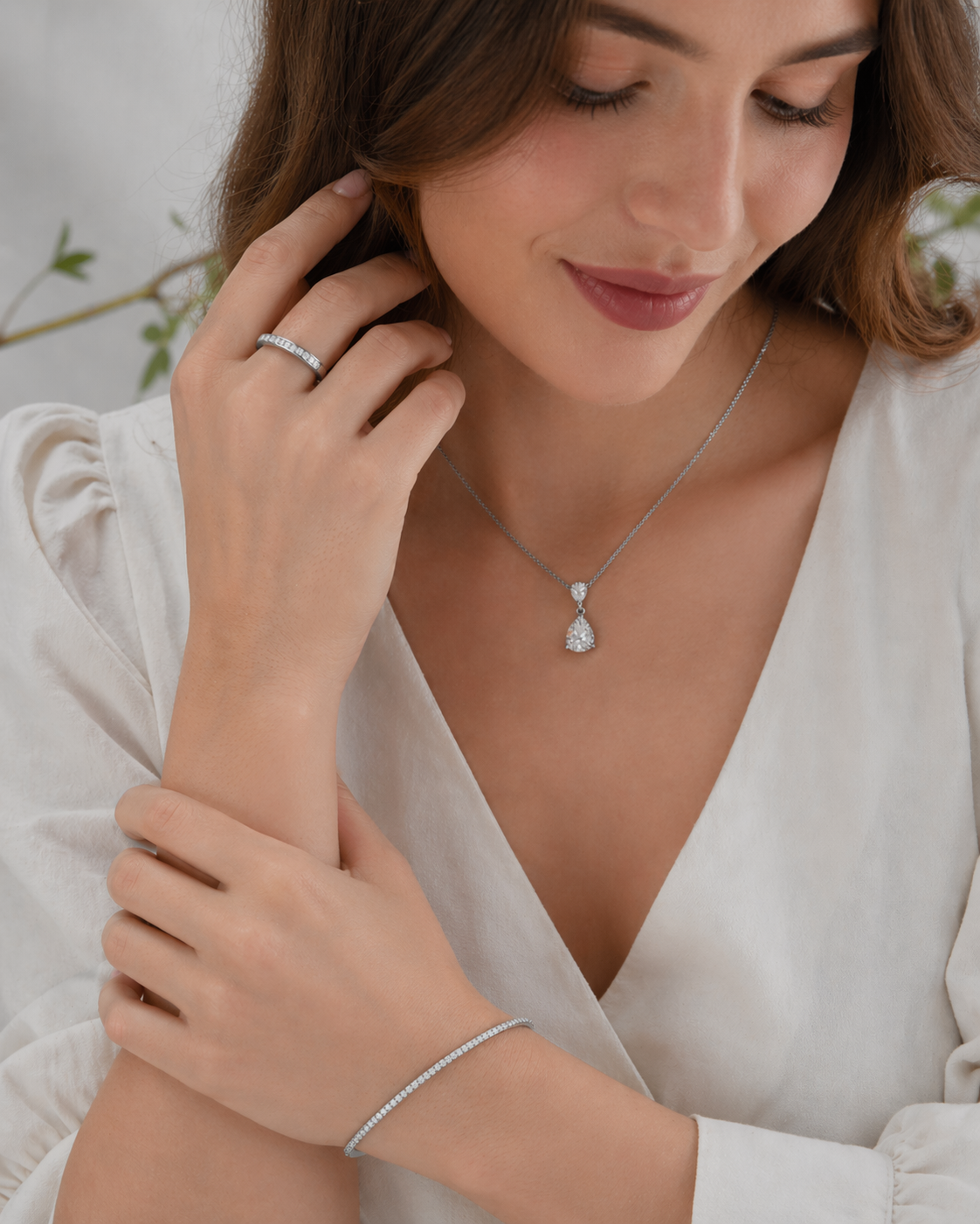 Elegant silver jewelry set featuring sparkling cubic zirconia stones: a delicate ring, minimalist bracelet, and refined teardrop pendant on a fine chain. Timeless design for modern, style-conscious women, perfect for everyday wear and special occasions.
