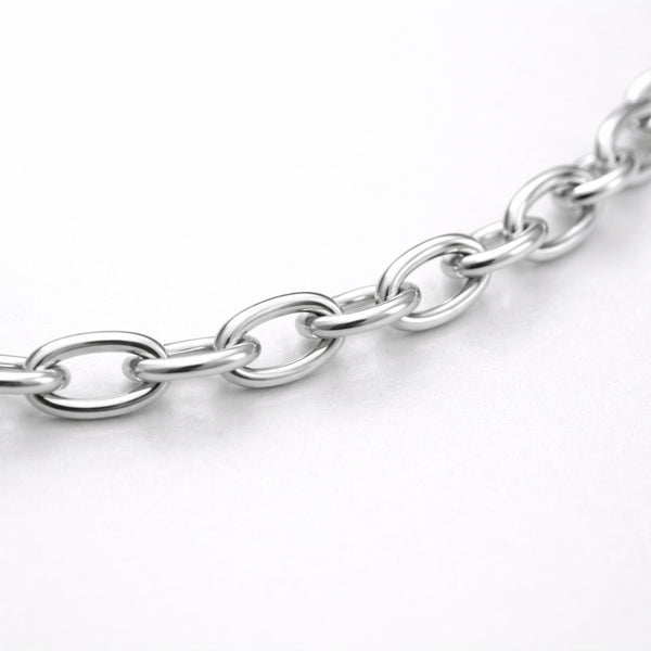 Studio view of a fine cable chain necklace with evenly spaced oval links in a polished silver tone finish.