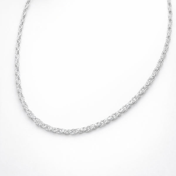Angled studio view of the twisted chain necklace emphasizing the braided twist structure, depth, and polished silver tone finish.
