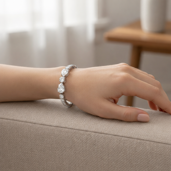 Tennis bracelet in silver tone worn on the wrist, showing elegant proportions and refined sparkle.