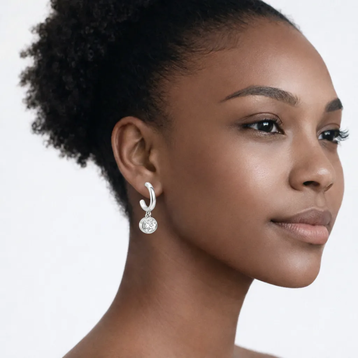 On-model portrait highlights drop hoop earrings with cubic zirconia, styled with bare shoulders so the earrings frame the face with high-polish shine.