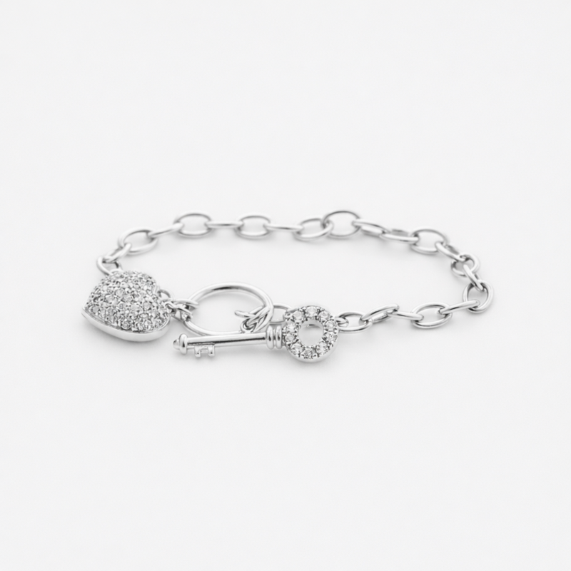 Studio image showing the full heart and key charm bracelet in silver tone with detailed chain design.