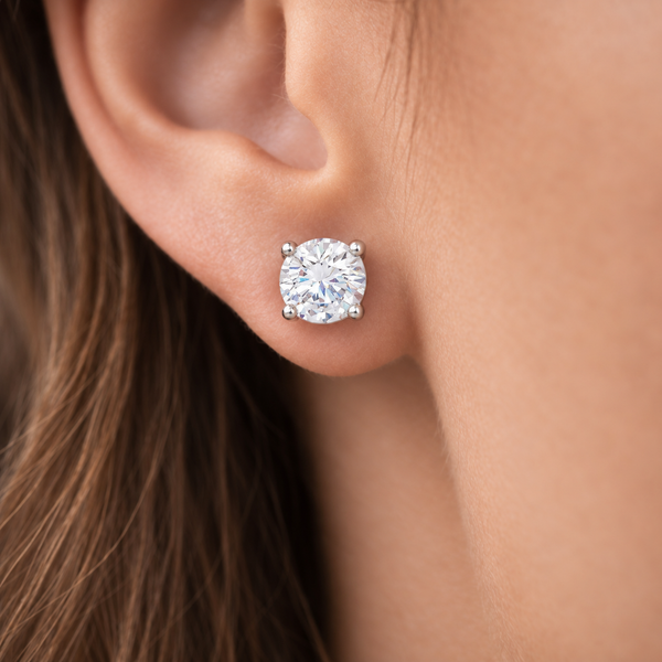 Jenny Round Clear Stone Stud Earrings in Silver Tone, worn on ear.