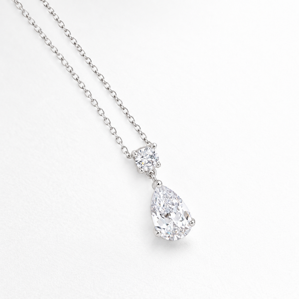 Round and Pear Clear Stone Drop Pendant in Silver Tone, angled view.