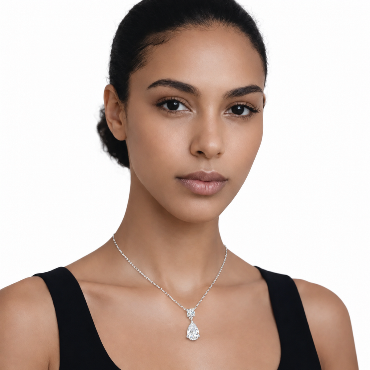Model wearing round and pear clear stone drop pendant in silver tone with a black top.