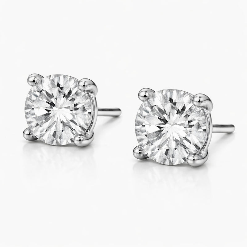 Front facing studio view of round silver tone stud earrings highlighting the symmetry, round cubic zirconia stones, and balanced prong placement.