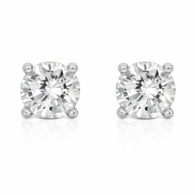 Studio view of a pair of round silver tone stud earrings featuring cubic zirconia stones secured in classic four prong settings.