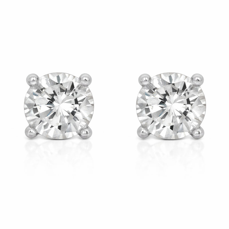 Studio view of a pair of round silver tone stud earrings featuring cubic zirconia stones secured in classic four prong settings.