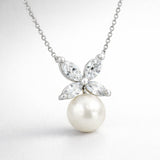 Detail view of the butterfly pendant highlighting the marquise cut cubic zirconia wing design and the smooth round pearl drop.
