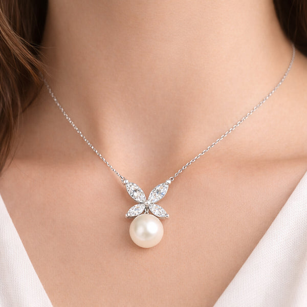 Worn view of the butterfly cubic zirconia and pearl pendant illustrating size, proportions, and drop length when worn.