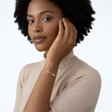 Model wearing clara clear station bracelet in silver tone with a black top.