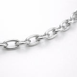 Studio view of a fine cable chain necklace with evenly spaced oval links in a polished silver tone finish.