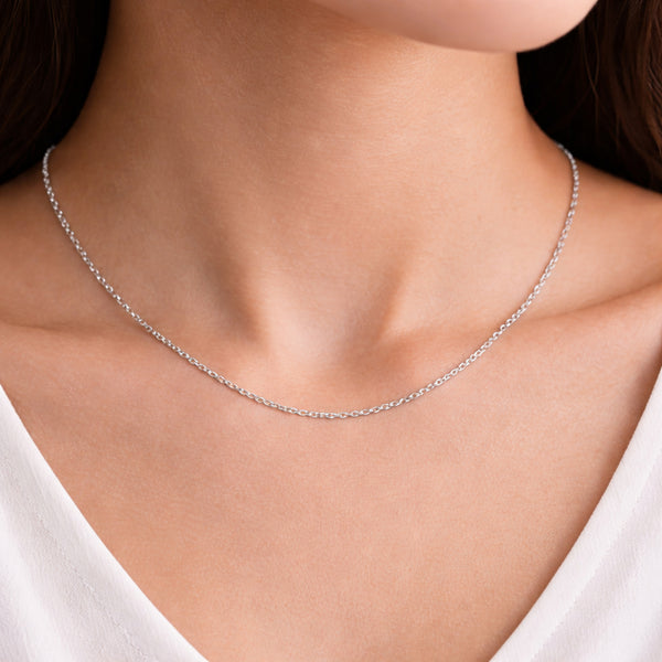 Cable chain necklace worn on the neck showing length, drape and subtle silver tone shine.