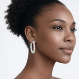 On-model portrait highlights classic hoop earrings with cubic zirconia, styled with bare shoulders so the earrings frame the face with high-polish shine.