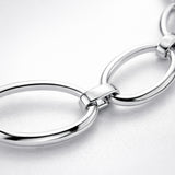 Close up detail highlighting the oval link structure and polished silver tone surface.