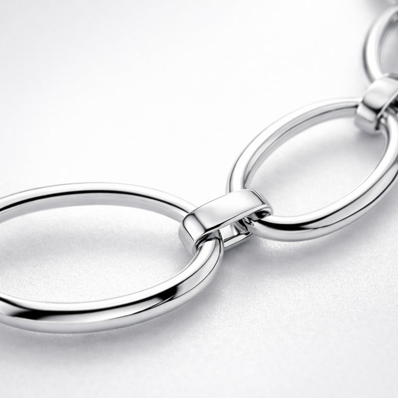Close up detail highlighting the oval link structure and polished silver tone surface.