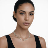 On-model portrait highlights a silver tone classic oval link chain necklace, styled with a black tank neckline so the chain drapes cleanly along the collarbone.