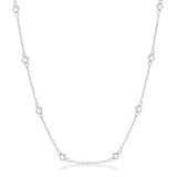 Front facing studio view of a silver tone station necklace featuring evenly spaced bezel set stones along a delicate chain.