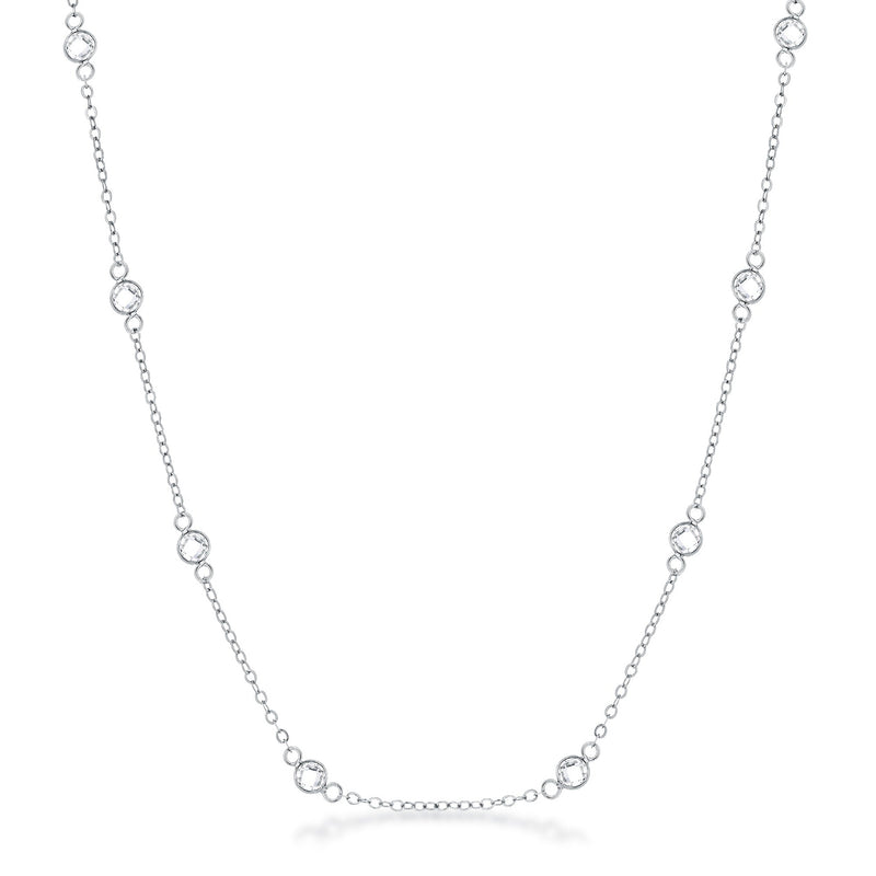 Front facing studio view of a silver tone station necklace featuring evenly spaced bezel set stones along a delicate chain.