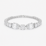 Studio view of a tennis bracelet featuring pear and round cut cubic zirconia set in rhodium plated brass.