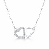 Front facing studio view of the double heart cubic zirconia pendant featuring one pavé set heart alongside one open heart in a balanced design.
