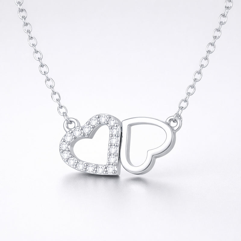 Studio view of the double heart cubic zirconia pendant centered to show the balanced heart design.