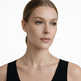 Model wearing endless whisper paperclip chain necklace in silver tone with a black top.