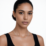 Model wearing endless whisper paperclip chain necklace in silver tone with a black top.