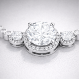 Close up view of the halo style centerpiece with round cut cubic zirconia stones in silver tone setting.