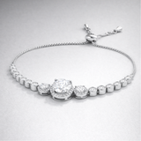 Close up view of the halo style centerpiece with round cut cubic zirconia stones in silver tone setting.