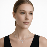 Model wearing heartbeat and heart necklace in silver tone with a black top.