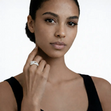 On-model portrait highlights a silver tone infinity pav cubic zirconia ring, styled with a black sleeveless top so the ring sparkles along the fingertips.