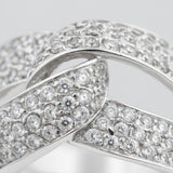 Close up view of an infinity pavé cubic zirconia ring in silver tone finish, highlighting the continuous infinity design and pavé set stones along the band.