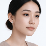 Model wearing julie polished ball stud earrings in silver tone with a neutral off-shoulder top.