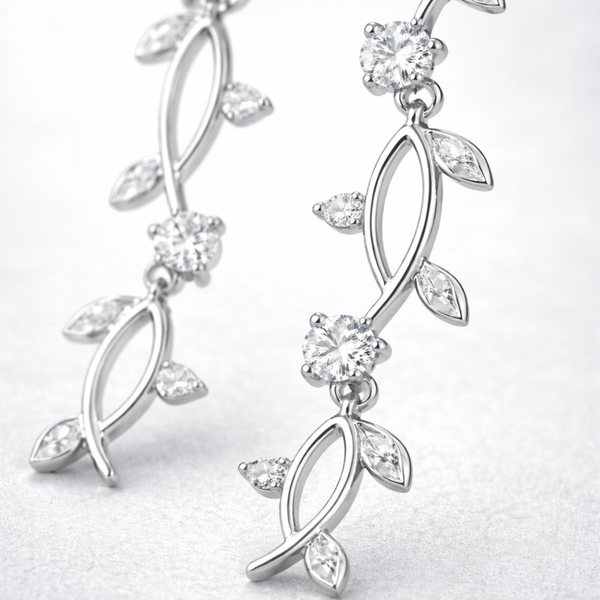 Close up view of the leaf motif drop earring showing polished silver tone finish and cubic zirconia details.