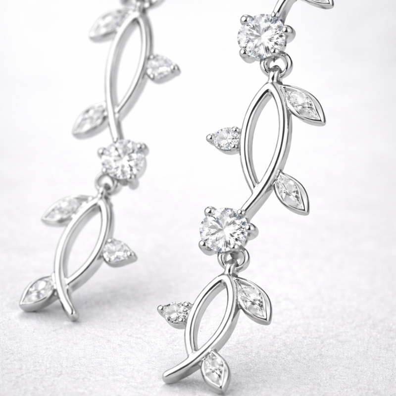 Close up view of the leaf motif drop earring showing polished silver tone finish and cubic zirconia details.
