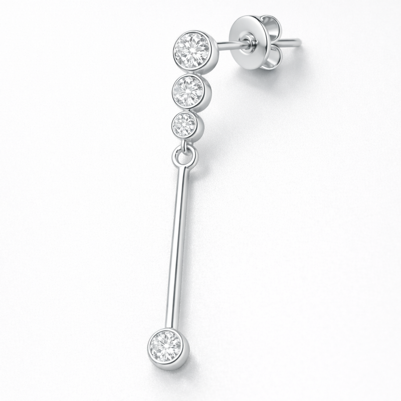 Close up detail of linear drop earring with bezel set cubic zirconia stones and polished silver tone finish.