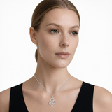 Model wearing open butterfly clear stone pendant in silver tone with a black top.