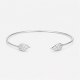 Front view of an open silver tone cuff bracelet featuring a smooth polished surface and cubic zirconia accents on both ends.