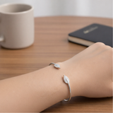 Open cuff bracelet worn on the wrist, highlighting modern shape and comfortable fit.