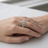Lifestyle view of a pavé chain link cubic zirconia ring in silver tone finish worn on the hand in a relaxed setting.