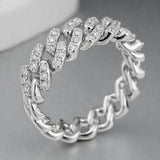 Studio view of a pavé chain link cubic zirconia ring in silver tone finish displayed against a neutral background.