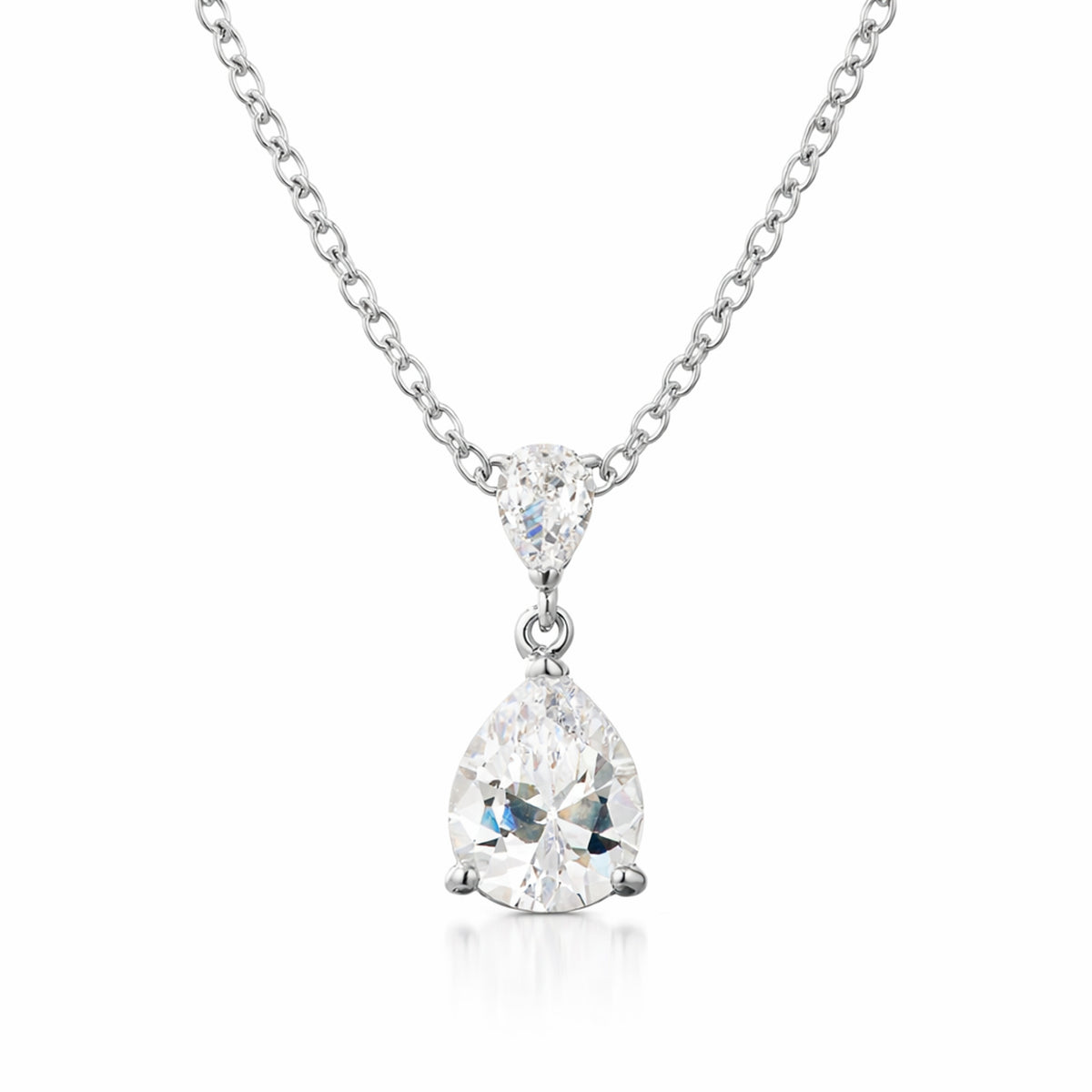 Studio view of a silver tone pear shaped drop pendant featuring a larger cubic zirconia suspended from a smaller pear shaped connector.