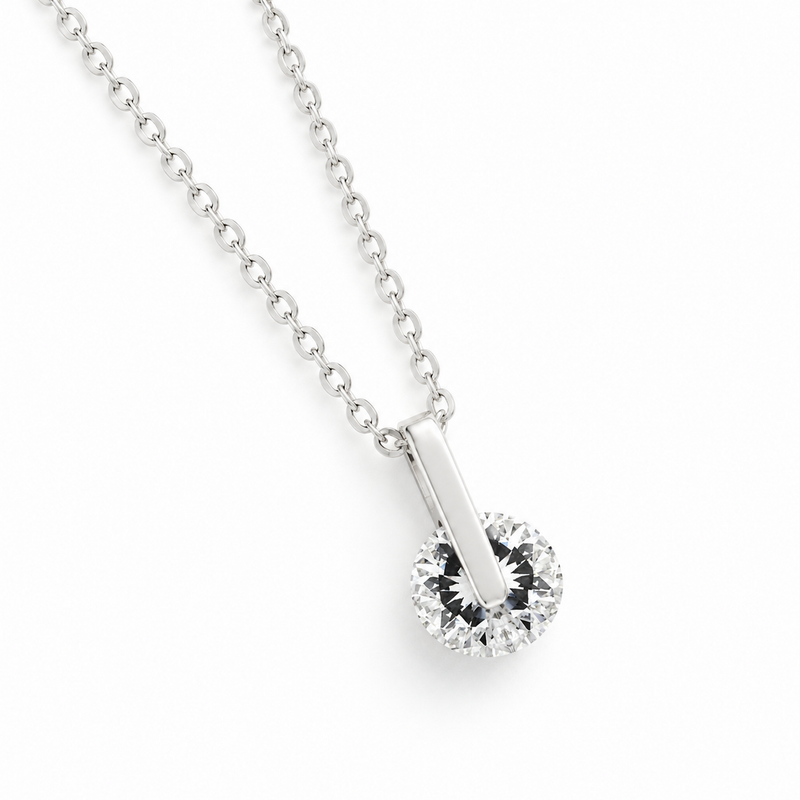 Polished Bar and Round Clear Stone Pendant in Silver Tone, angled view.