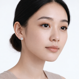 Model wearing rachel round clear stone stud earrings in silver tone with a neutral off-shoulder top.