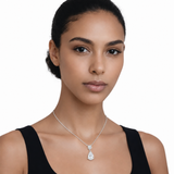 Model wearing round and pear clear stone drop pendant in silver tone with a black top.