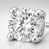 Detailed close up of a round silver tone stud earring showcasing the brilliant cubic zirconia stone and smooth four prong metal setting.