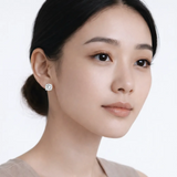 Model shot captures round stud earrings with cubic zirconia, styled with an off-shoulder neckline so the earrings frame the face with high-polish shine.