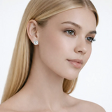 Model view showcases silver tone round stud earrings with cubic zirconia, styled with bare shoulders so the earrings frame the face with high-polish shine.