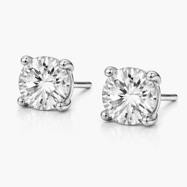 Front facing studio view of round silver tone stud earrings highlighting the symmetry, round cubic zirconia stones, and balanced prong placement.